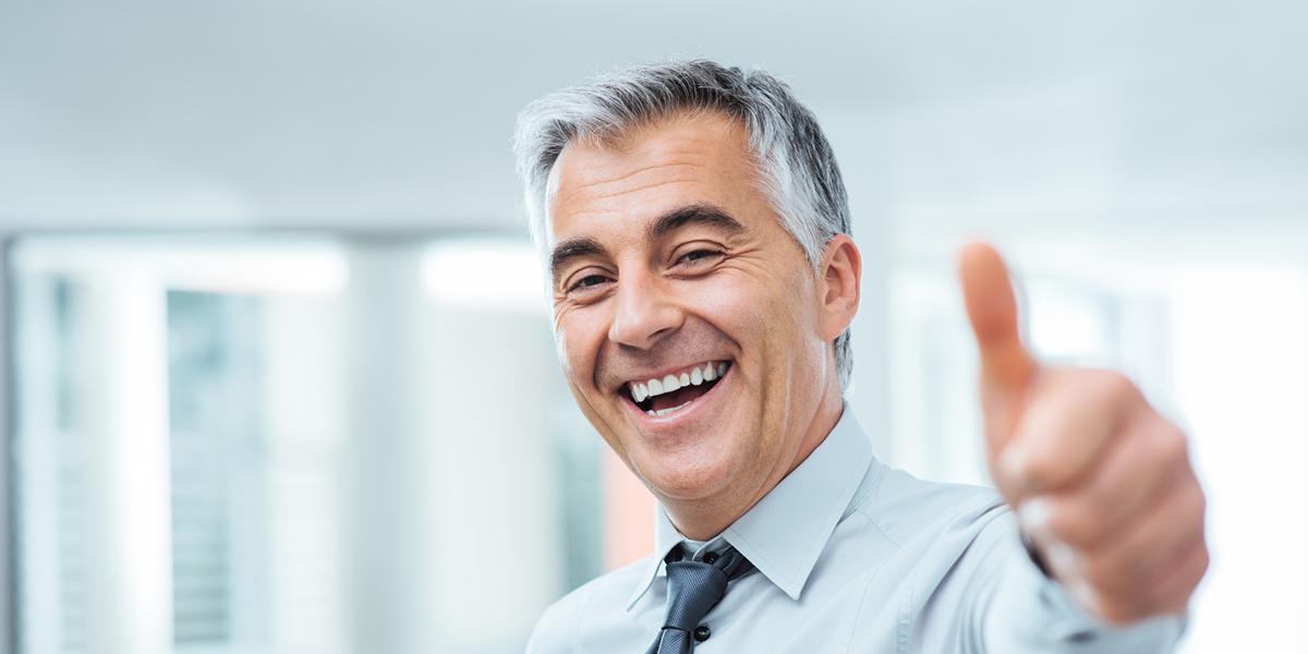 man smiling with outreached hand