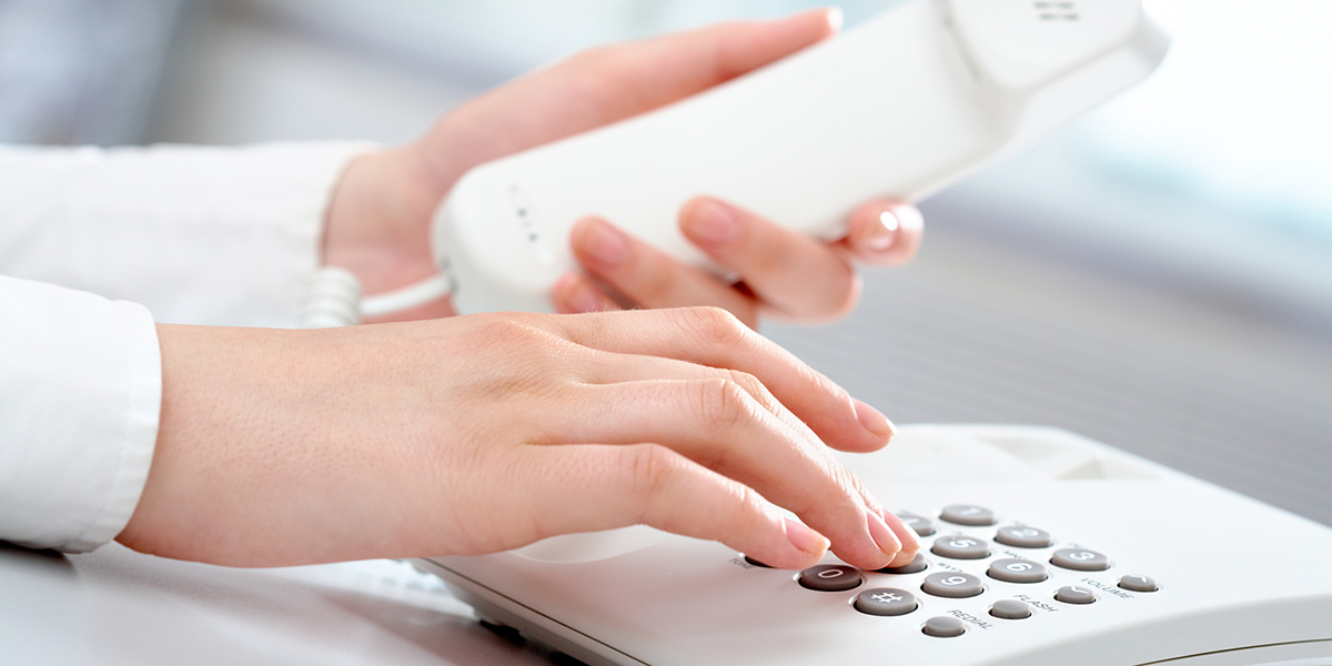 hands dialing a phone